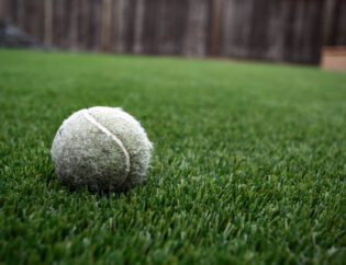 Close up of tennis ball on artificial grass