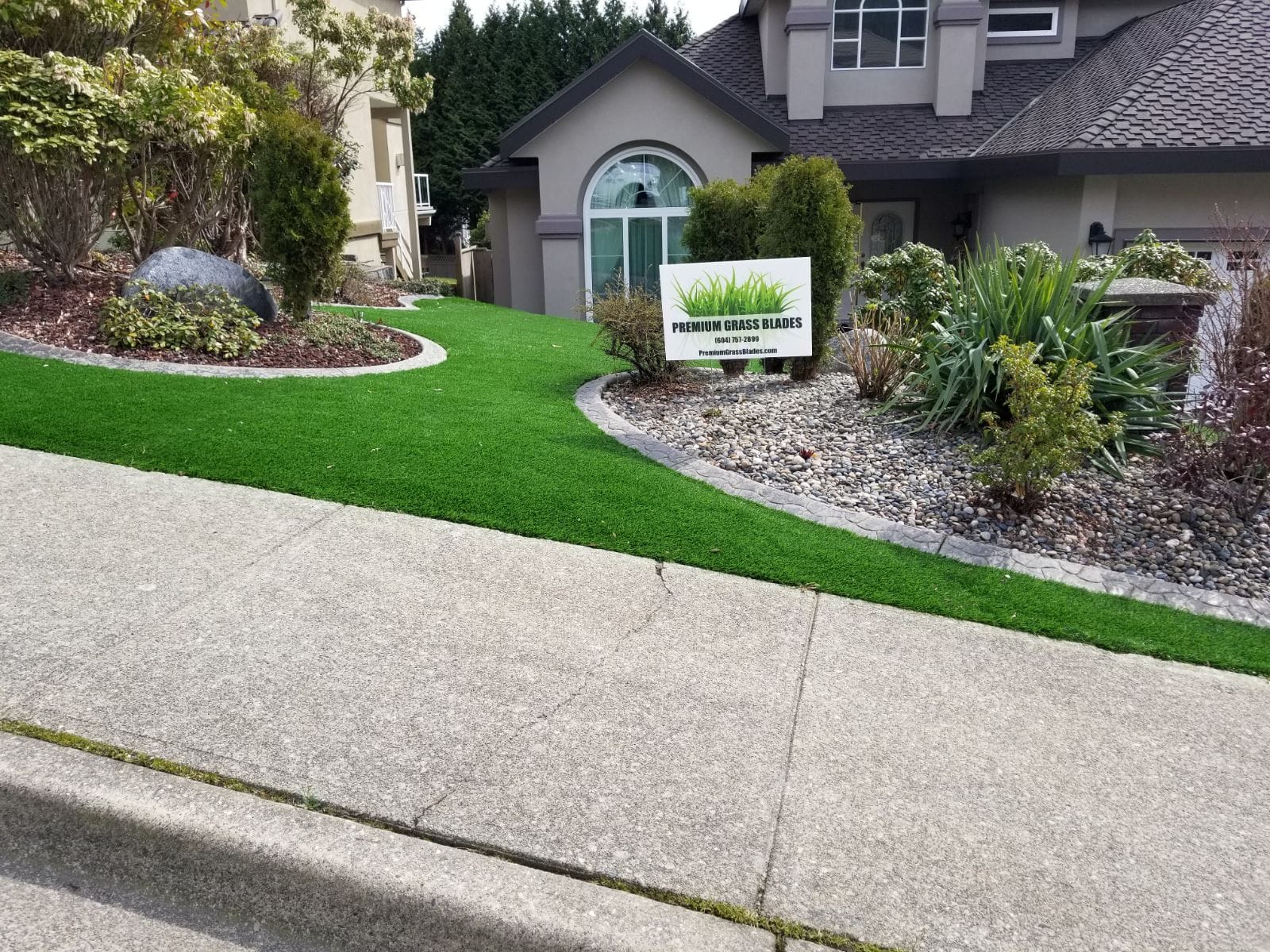 Premium Grass Blades Synthetic Artificial Turf Lush in Coquitlam with natural rock garden- Low Maintainance